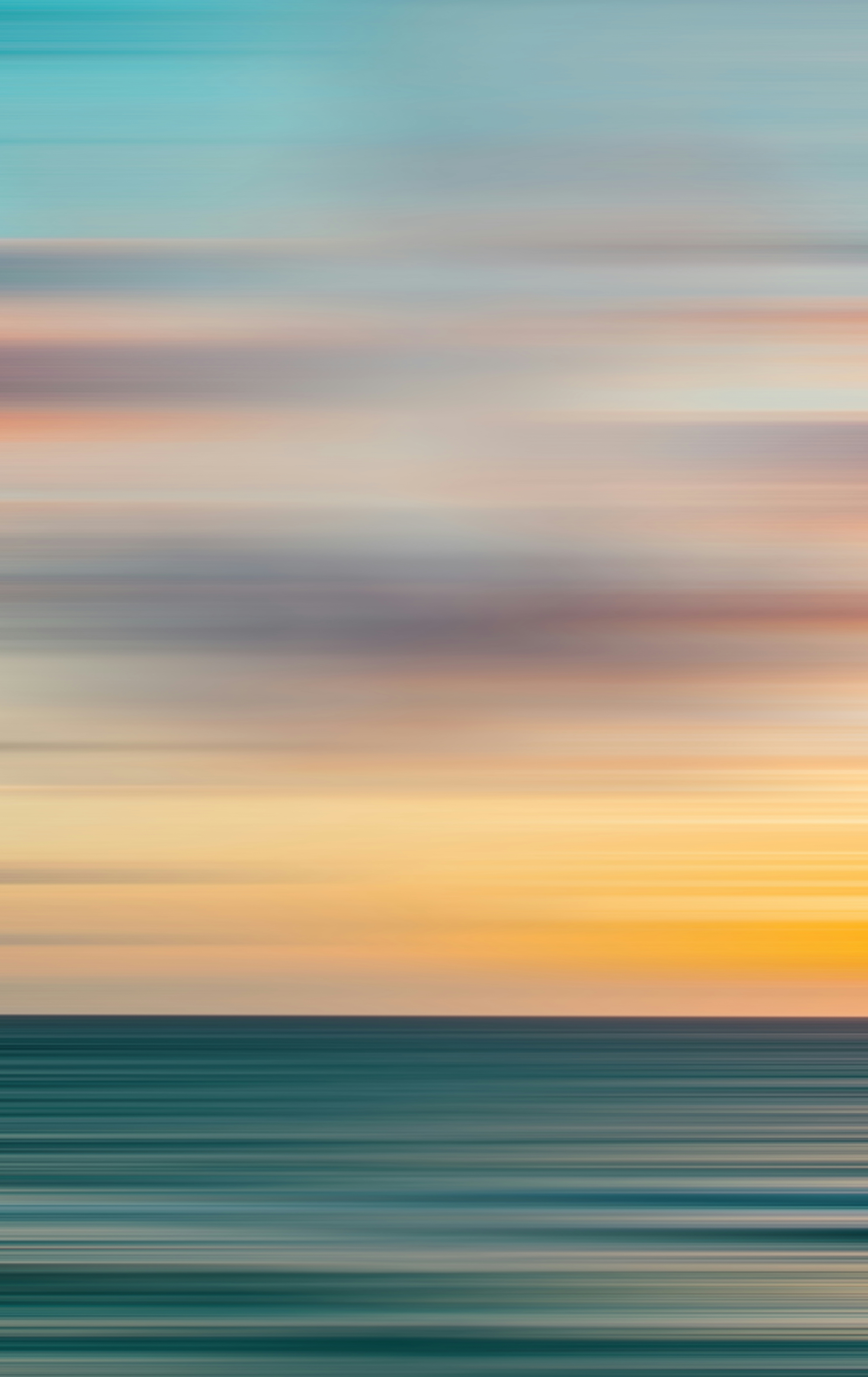blurry photo of sunset over ocean with logo on top